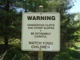 [Photo of sign warning of "dangerous cliffs and steep slopes"]